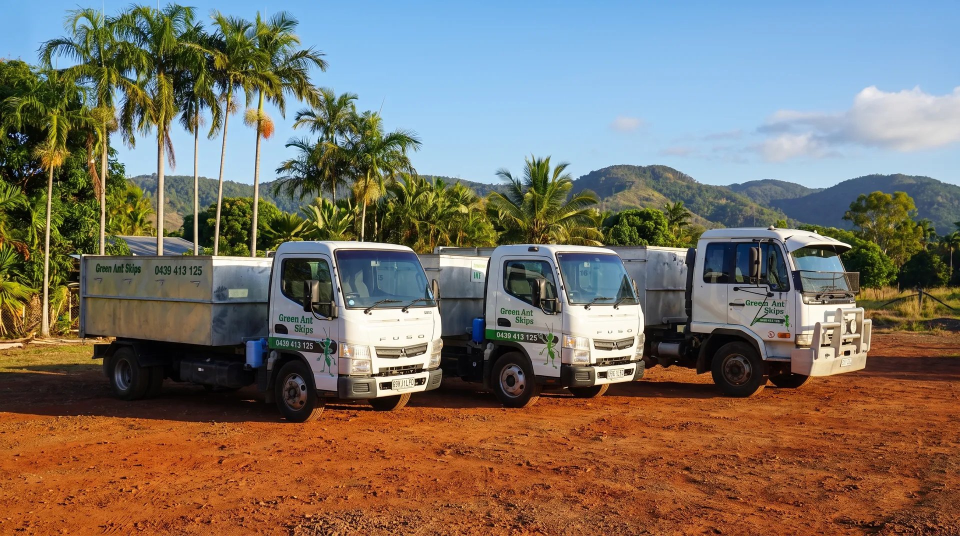 Green Ant Skips truck fleet with the Townsville hills behind