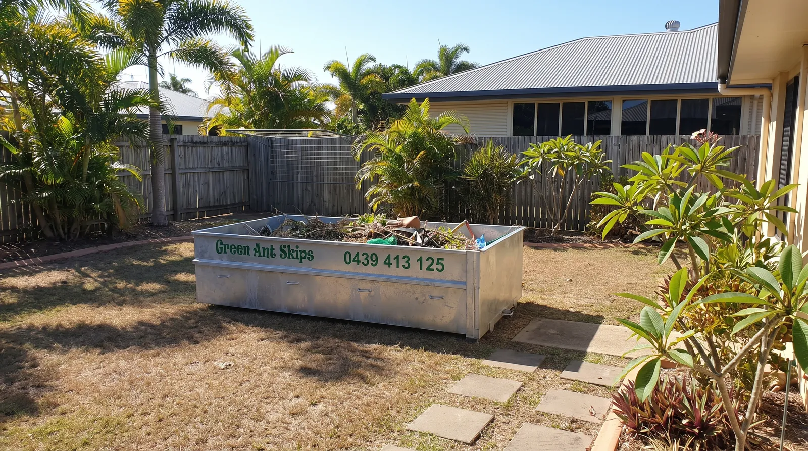 Green Ant Skips skip bin on a Townsville backyard lawn
