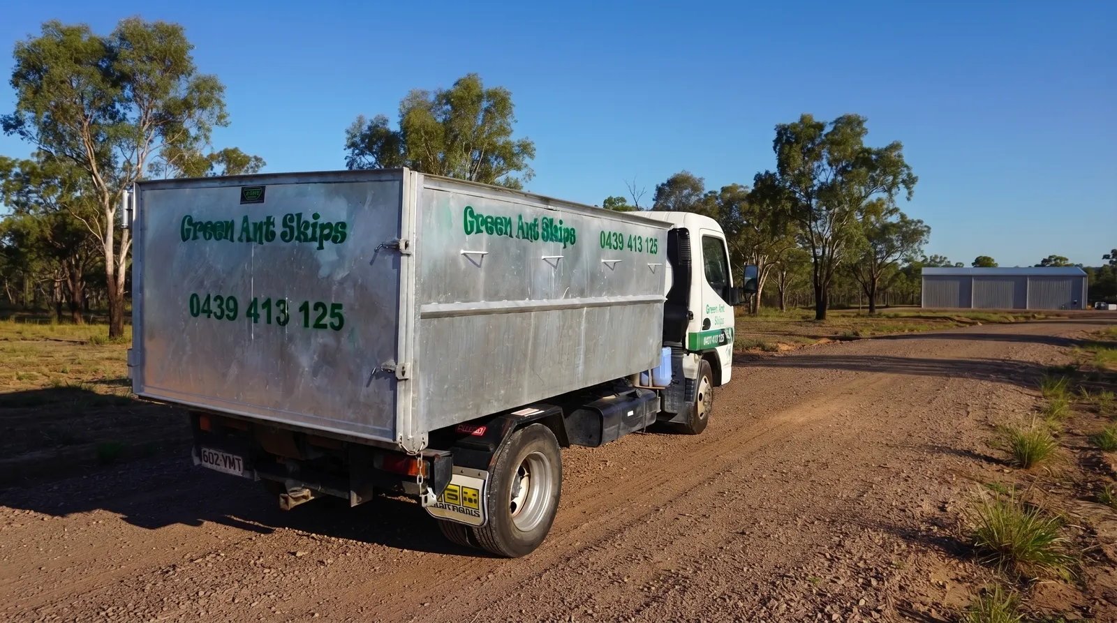 Skip bin hire Townsville — a Green Ant Skips truck on a North Queensland road